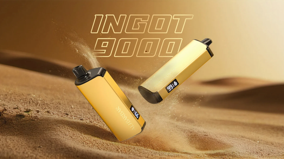 Two gold Ingot 9000 disposable vapes floating above desert sand dunes.
